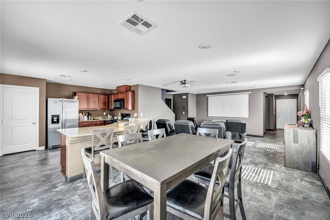 1205 Deep Valley Avenue, North Las Vegas, NV 89084 An open layout integrates the dining area with a modern kitchen and adjacent media space.