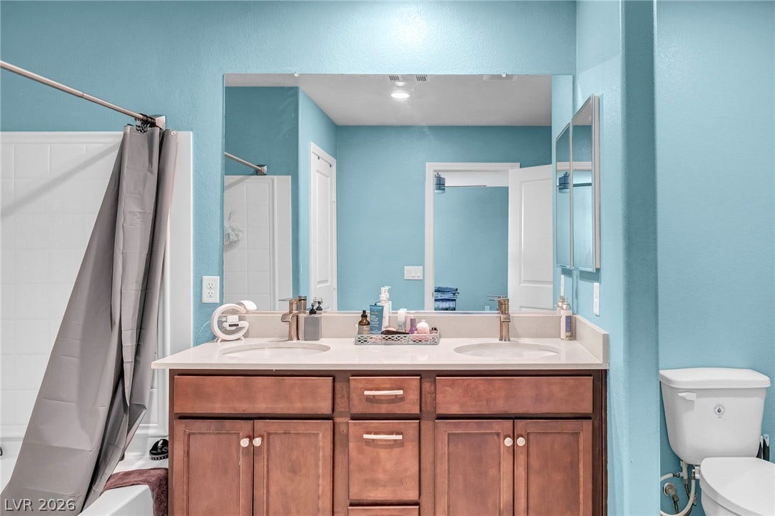 1205 Deep Valley Avenue, North Las Vegas, NV 89084 A spacious double vanity anchors this functional bathroom space.