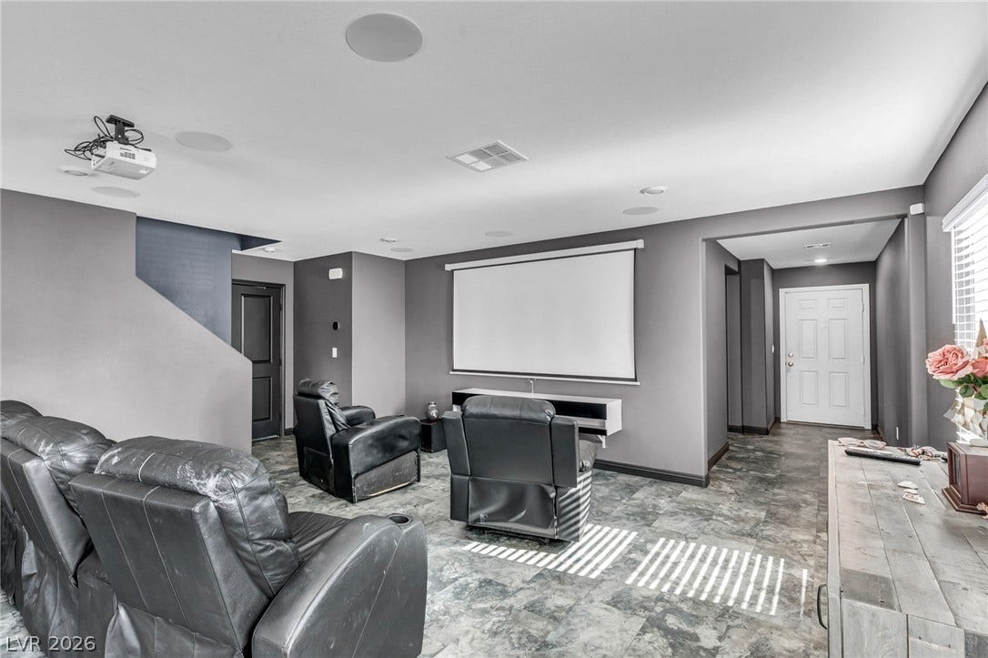 1205 Deep Valley Avenue, North Las Vegas, NV 89084 Tiled flooring and a built-in projection screen define this versatile lower-level entertainment space.