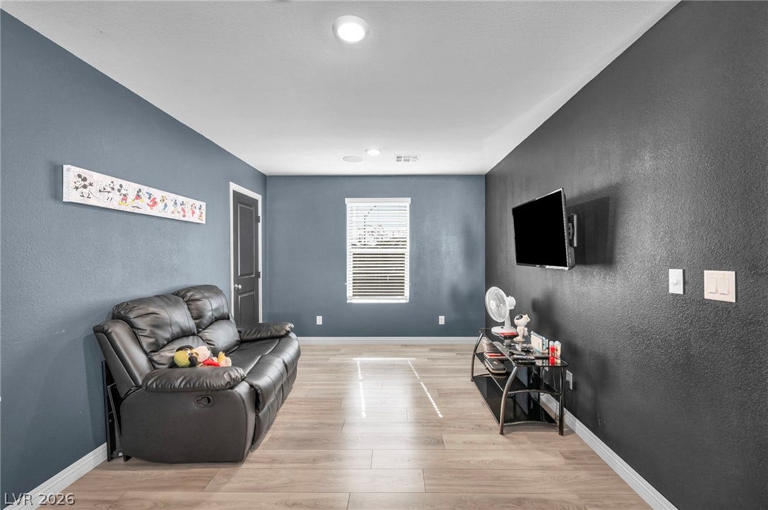 1205 Deep Valley Avenue, North Las Vegas, NV 89084 Smooth wood-style flooring runs through this versatile media room featuring recessed overhead lighting.