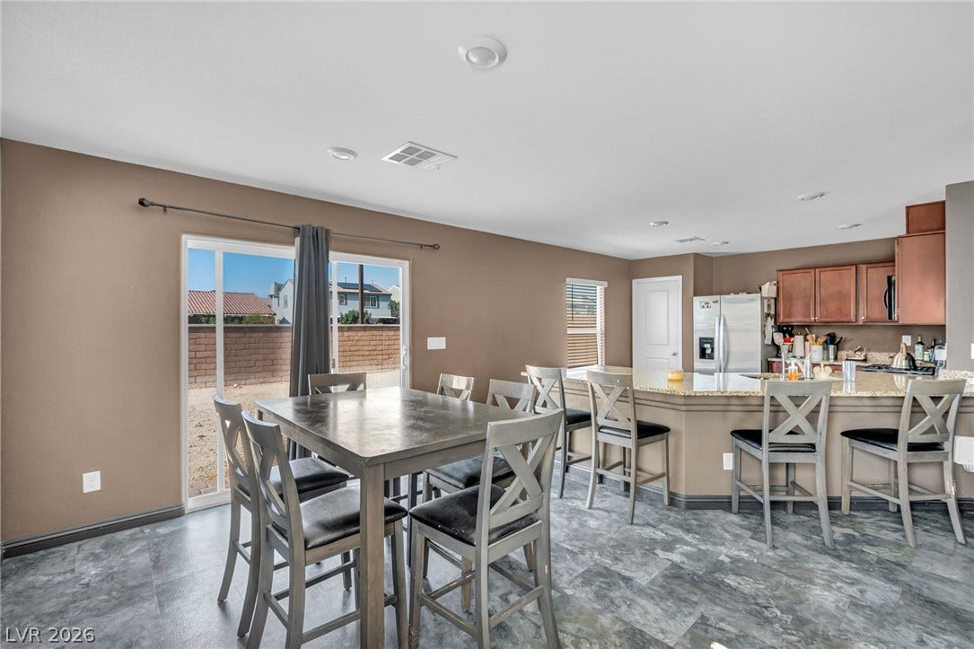 1205 Deep Valley Avenue, North Las Vegas, NV 89084 A spacious dining area features stone-patterned tile flooring and opens directly into the kitchen.