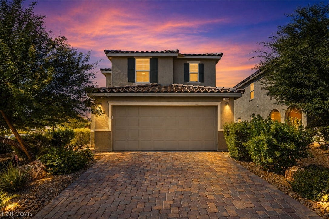 1205 Deep Valley Avenue, North Las Vegas, NV 89084 An inviting two-story exterior showcases a paved driveway leading to a two-car garage.