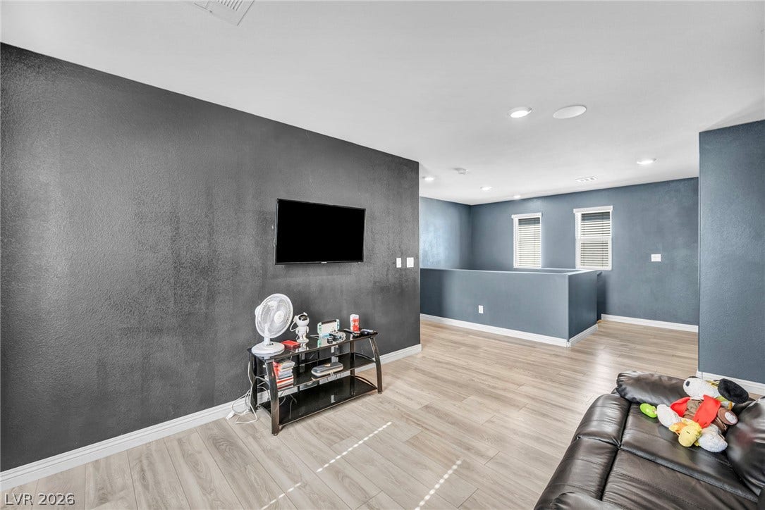 1205 Deep Valley Avenue, North Las Vegas, NV 89084 Smooth wood-look flooring and recessed lighting define this versatile second-story loft space.