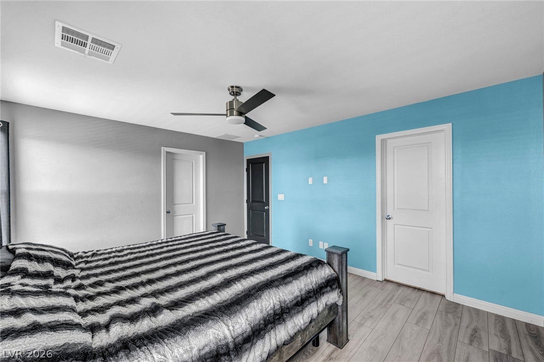 1205 Deep Valley Avenue, North Las Vegas, NV 89084 Gleaming wood-look floors complement the clean lines of this modern bedroom.