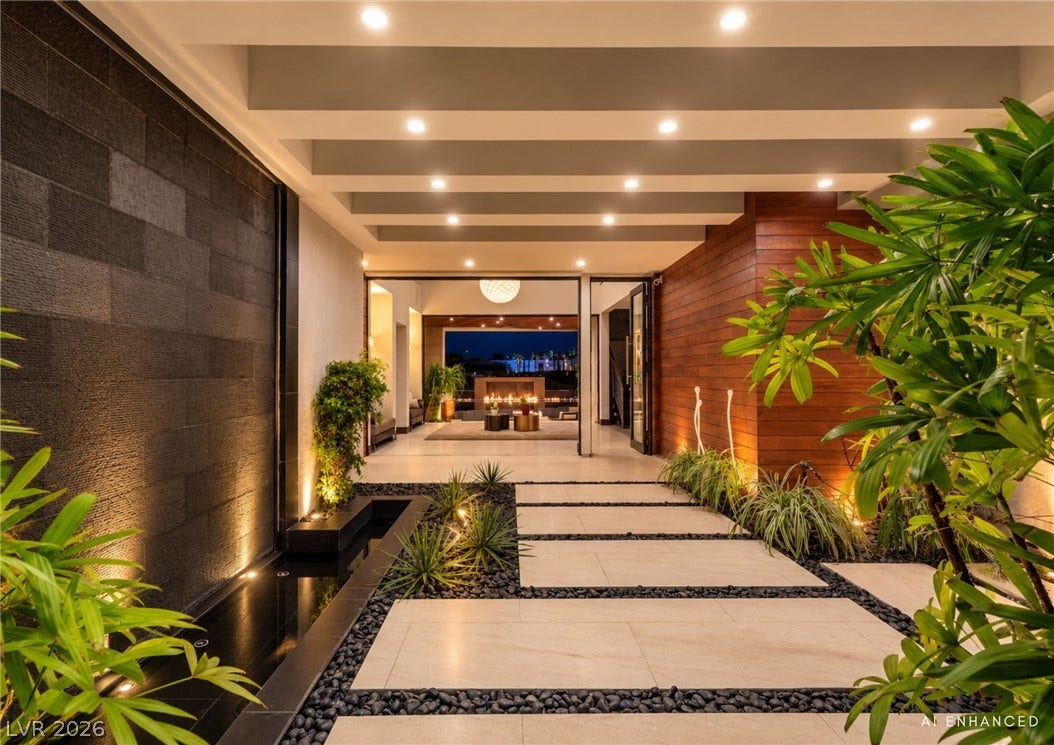 1269 Imperia Drive, Henderson, NV 89052 A grand sheltered entryway showcases sleek paving stones alongside a tranquil modern water feature.