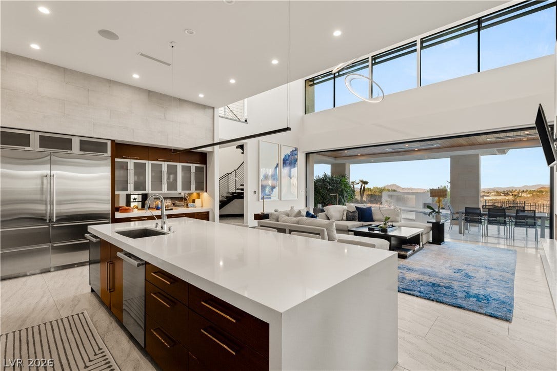 1269 Imperia Drive, Henderson, NV 89052 Double-height ceilings and a massive kitchen island define this striking open-concept living space.