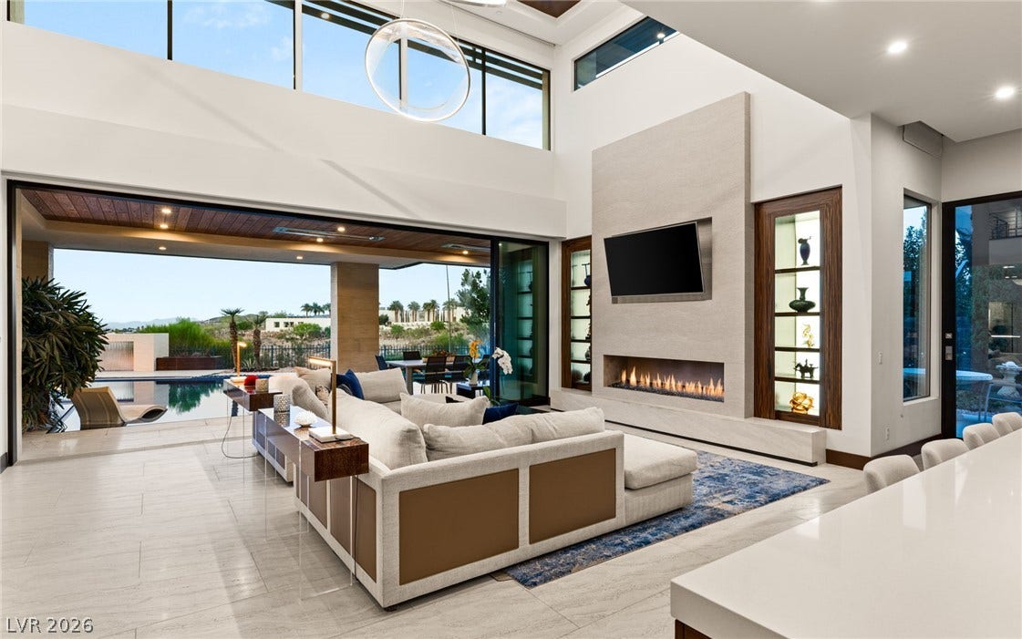 1269 Imperia Drive, Henderson, NV 89052 Towering ceilings and pocketing glass doors define this open, light-filled great room.