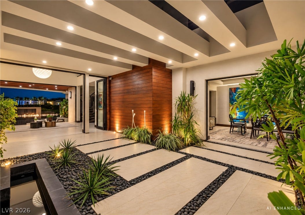 1269 Imperia Drive, Henderson, NV 89052 Bold architectural beams and integrated ground lighting define this modern entryway courtyard.