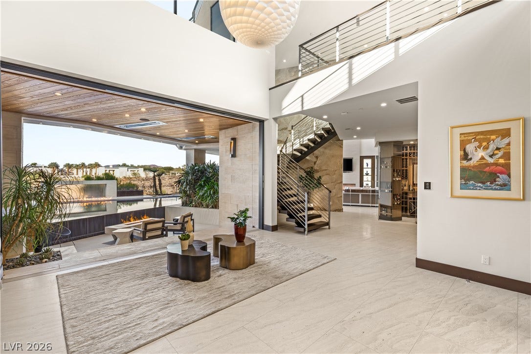 1269 Imperia Drive, Henderson, NV 89052 Retracting glass walls seamlessly merge the airy foyer with a resort-style outdoor patio.