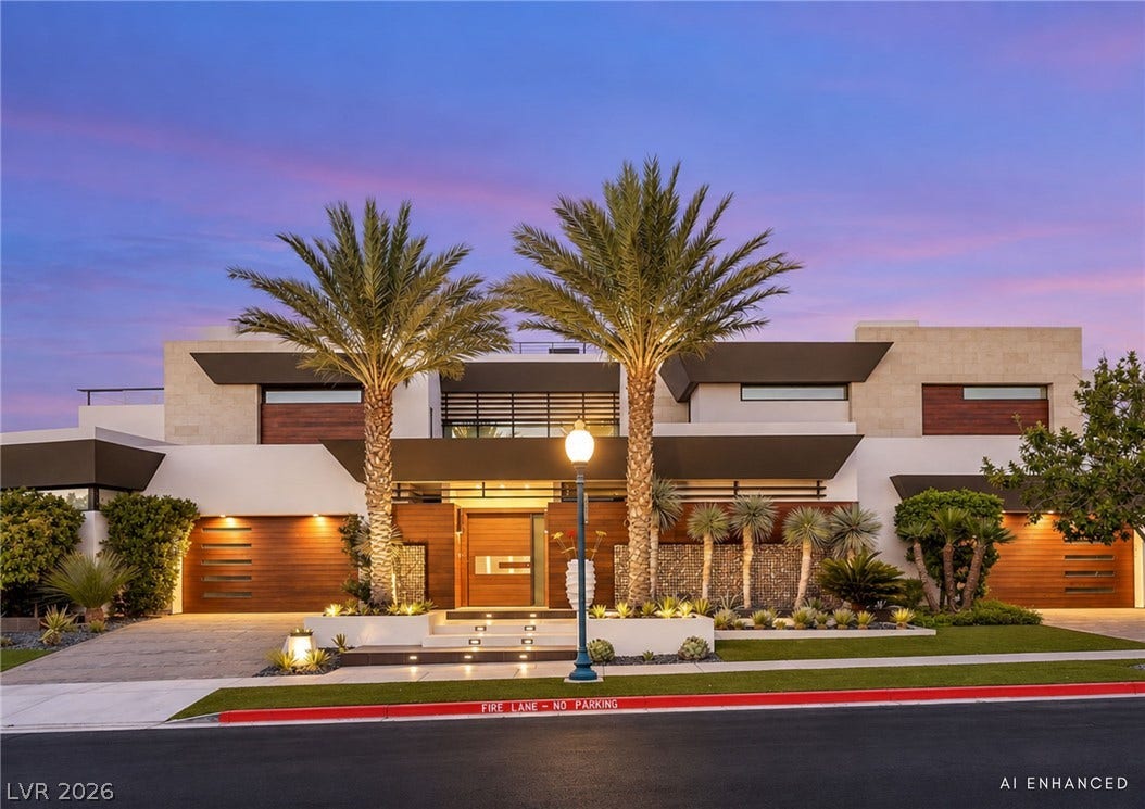 1269 Imperia Drive, Henderson, NV 89052 Dramatic modern architecture meets manicured tropical landscaping under a twilight sky.