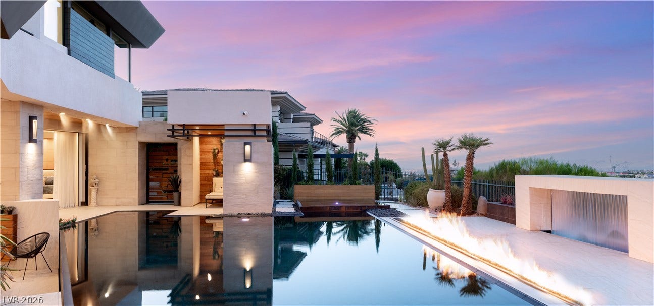 1269 Imperia Drive, Henderson, NV 89052 An elegant infinity pool and custom fire feature frame sweeping twilight views.