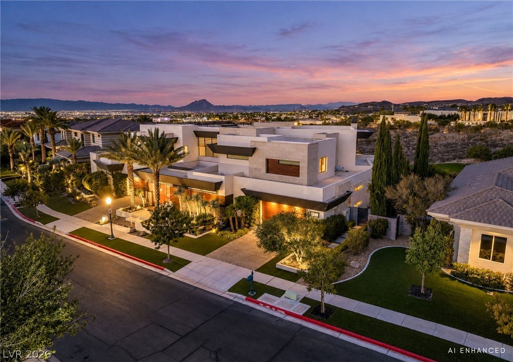 1269 Imperia Drive, Henderson, NV 89052 Bold contemporary architecture stands out against a backdrop of distant mountains and evening skies.