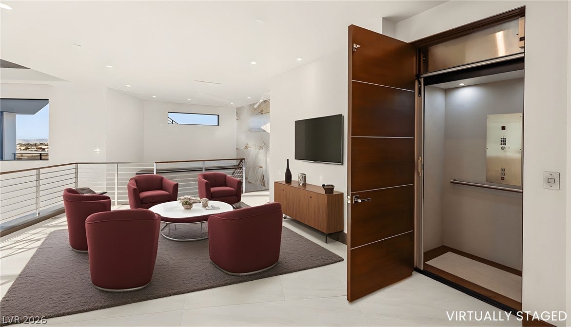 1269 Imperia Drive, Henderson, NV 89052 Multi-level modern living space showcasing a private elevator entrance and clean lines.