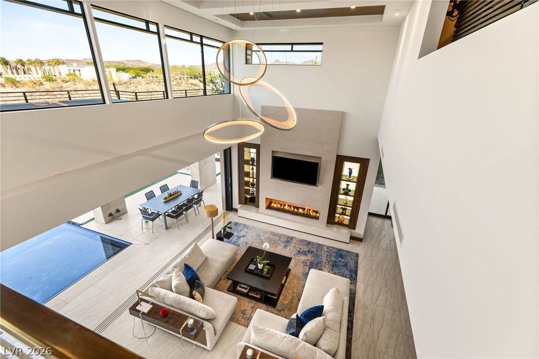 1269 Imperia Drive, Henderson, NV 89052 Soaring ceilings and expansive windows frame desert mountain views from this light-filled modern living space.