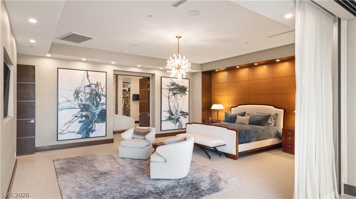 1269 Imperia Drive, Henderson, NV 89052 Gleaming hardwood floors and a customized wood-paneled headboard wall anchor this refined suite.