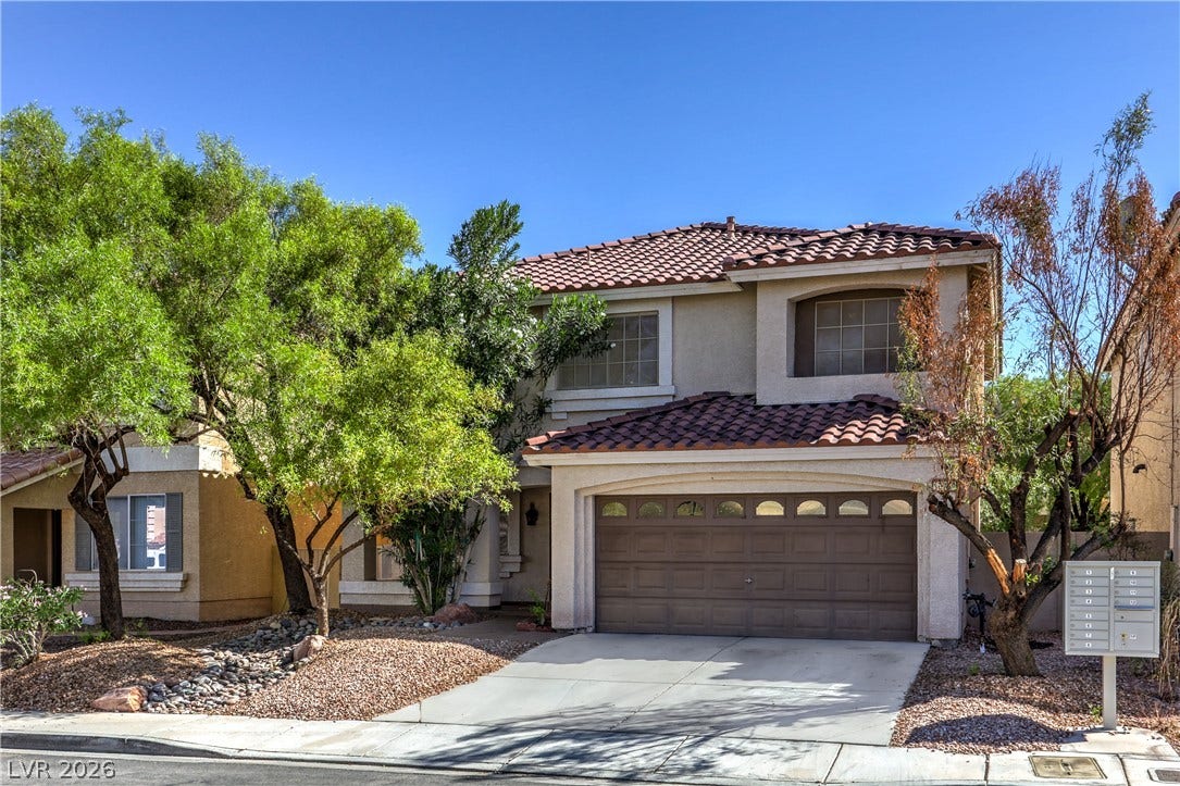 10744 Teton Village Court, Henderson, NV 89052 A classic Spanish tile roof and concrete driveway define this two-story stucco exterior.