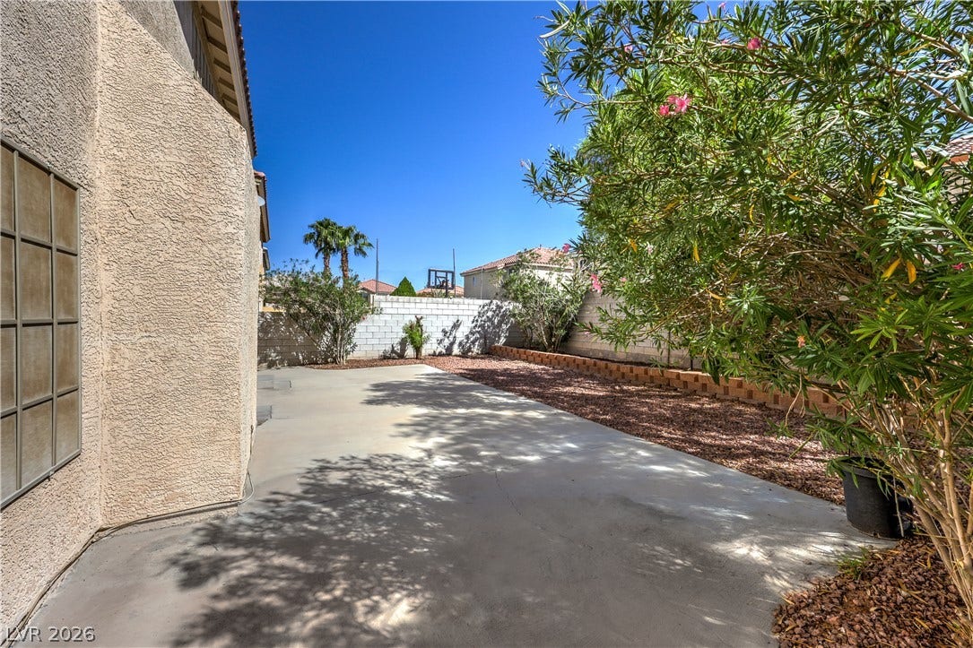 10744 Teton Village Court, Henderson, NV 89052 A low-maintenance concrete patio area provides a private outdoor retreat alongside stucco walls.