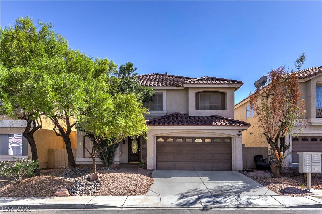 10744 Teton Village Court, Henderson, NV 89052 Spanish tile roofing and an integrated two-car garage define this classic suburban exterior.