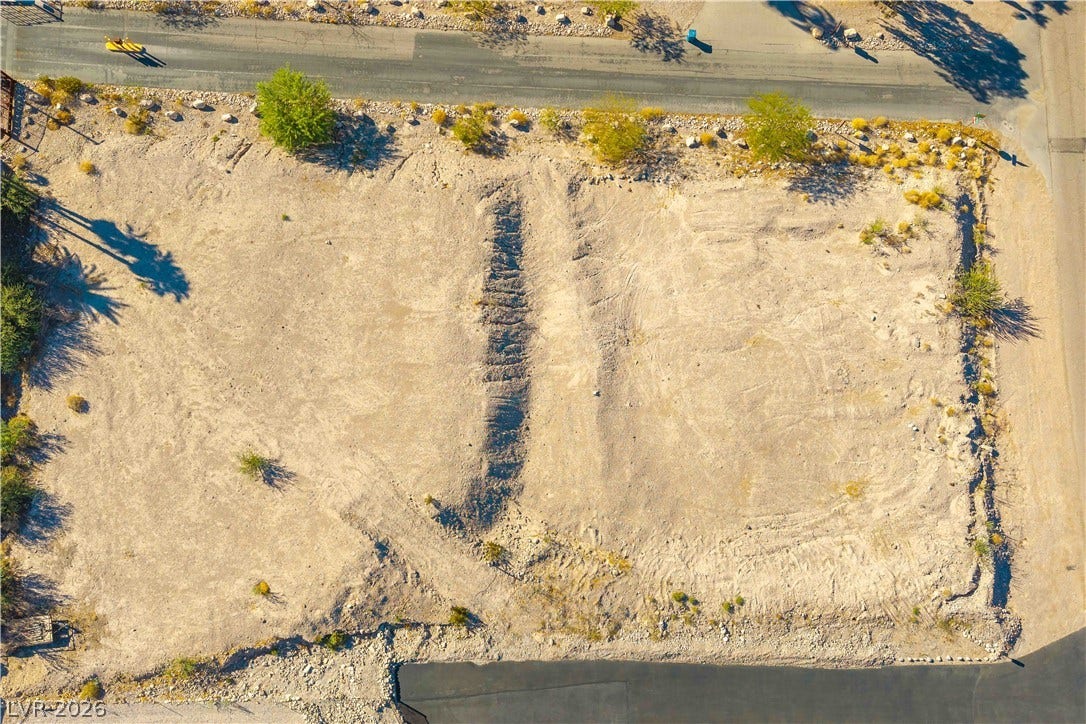 520 Los Feliz Street, Las Vegas, NV 89110 A leveled building lot awaits construction among Ranch Style Estate homes with mountain and Strip views.
