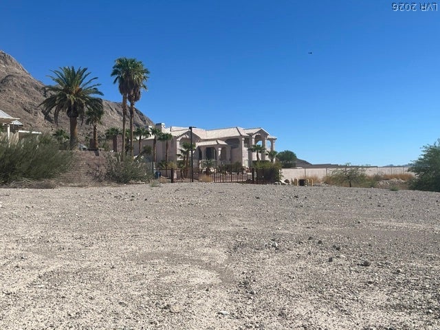 520 Los Feliz Street, Las Vegas, NV 89110 Desert landscaping and towering palms frame a custom residence set against a mountain backdrop.