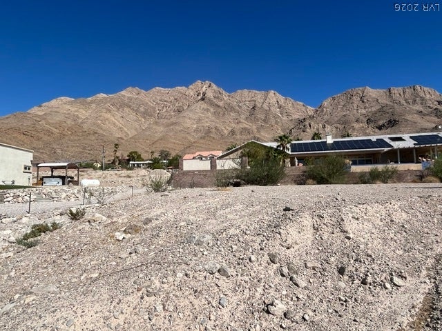 520 Los Feliz Street, Las Vegas, NV 89110 Dramatic mountain peaks rise sharply behind the properties under a clear blue sky.
