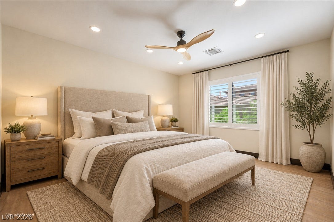 18 Wade Hampton Trail, Henderson, NV 89052 Virtually Staged.
A window with built-in shutters illuminates this serene bedroom complete with recessed lighting.