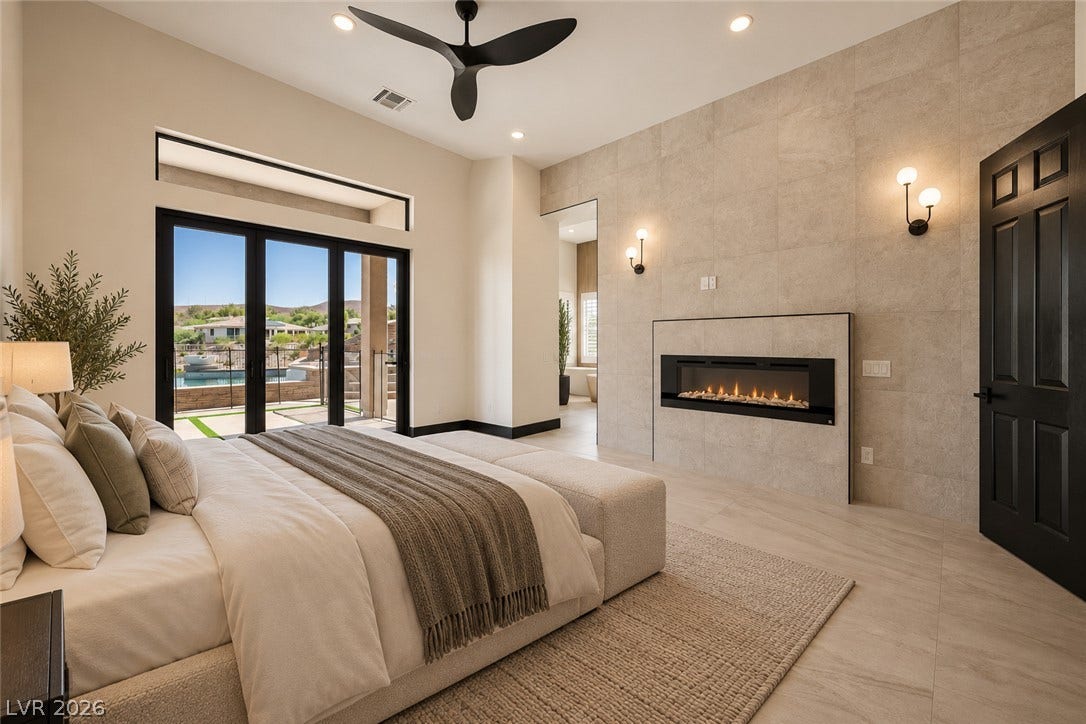18 Wade Hampton Trail, Henderson, NV 89052 Virtually Staged. Clean lines and a modern fireplace elevate this peaceful bedroom retreat.