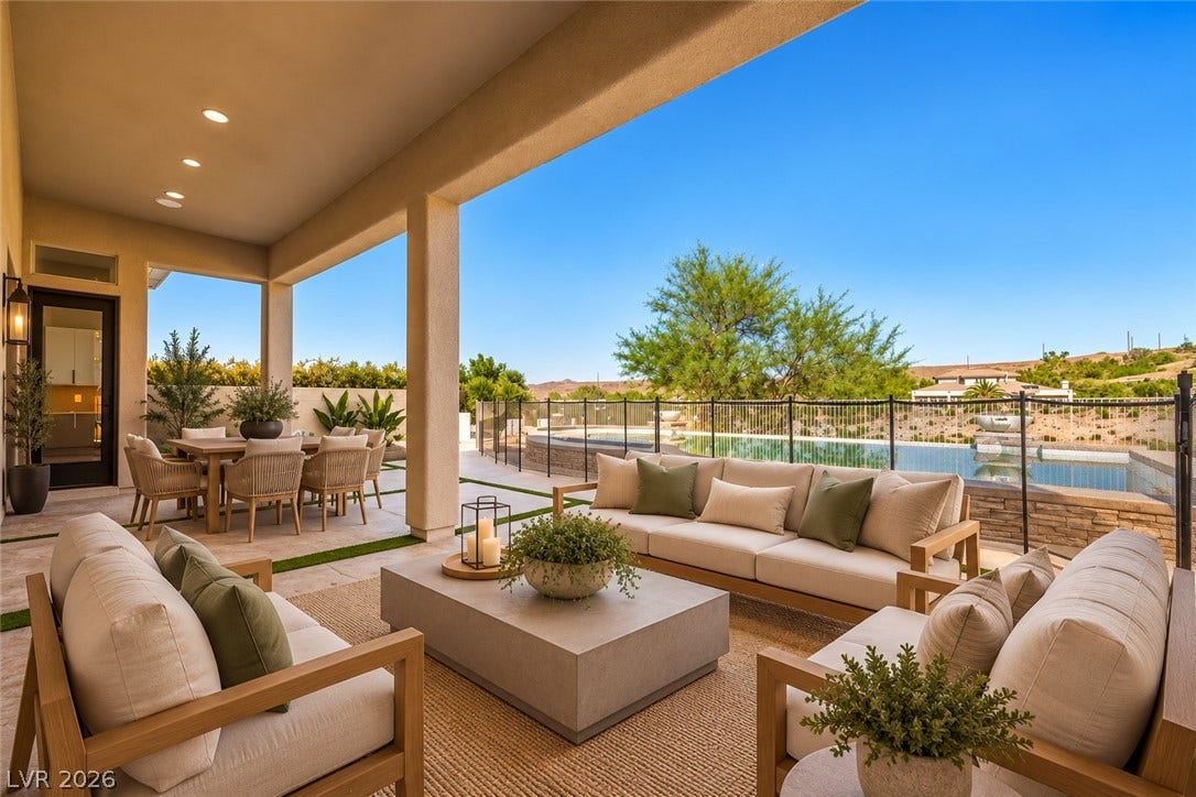 18 Wade Hampton Trail, Henderson, NV 89052 Virtually Staged.
An inviting covered patio offers seamless indoor-outdoor transition alongside a sparkling pool and desert views.