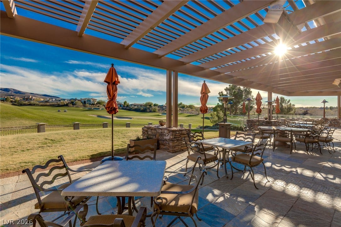 18 Wade Hampton Trail, Henderson, NV 89052 An expansive stone patio covered by a large wooden pergola overlooks the adjacent golf course.