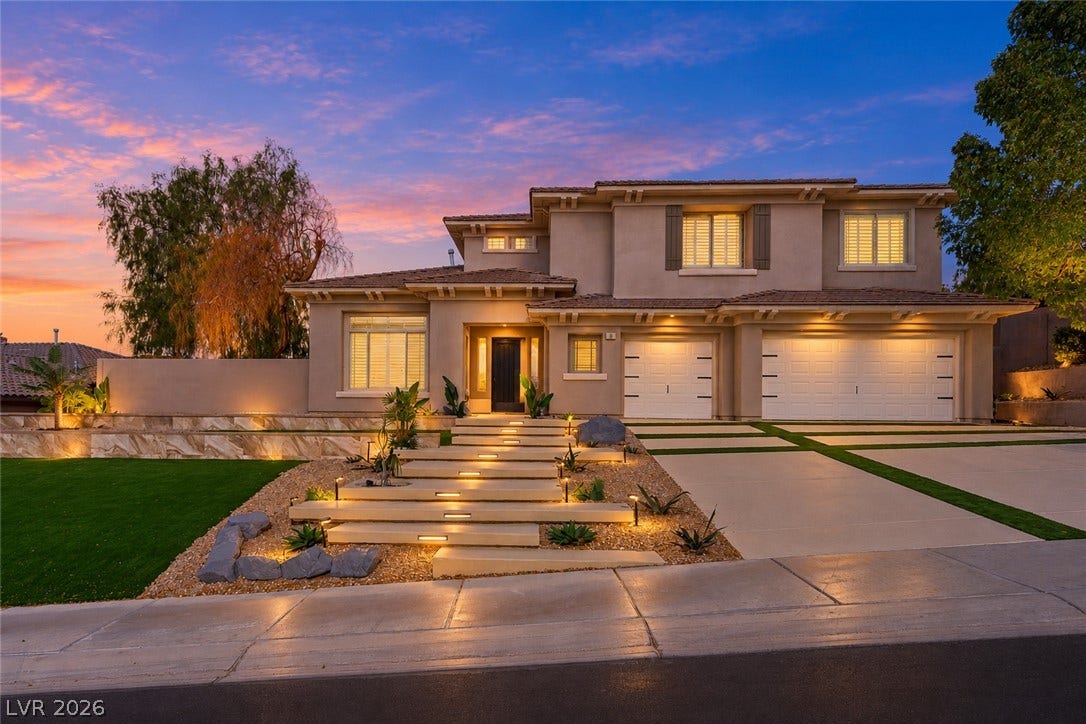 18 Wade Hampton Trail, Henderson, NV 89052 Virtually Staged.
An illuminated multi-tiered walkway leads past manicured landscaping to this elegant two-story stucco residence.
