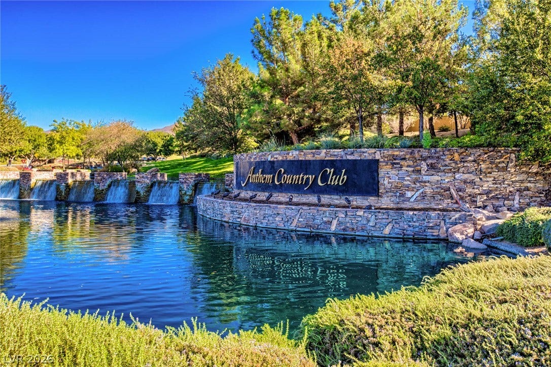 18 Wade Hampton Trail, Henderson, NV 89052 Lush landscaping and stone water features frame the entrance to this premier neighborhood community.
