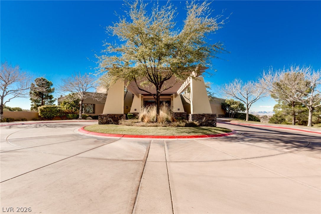 18 Wade Hampton Trail, Henderson, NV 89052 A grand porte-cochere sits at the end of a sweeping circular concrete driveway.