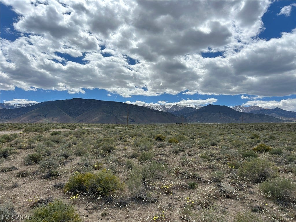233 MOUNTAIN WATER RANCH, Dyer, NV 89010 Panoramic mountain views highlight this vast desert acreage under a dramatic blue sky.