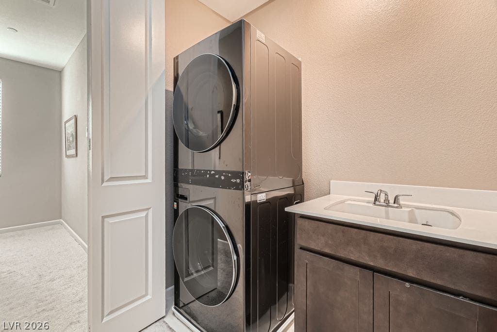 2507 Silent View Avenue, Henderson, NV 89044 An integrated utility space features a stacked washer and dryer next to a modern vanity.