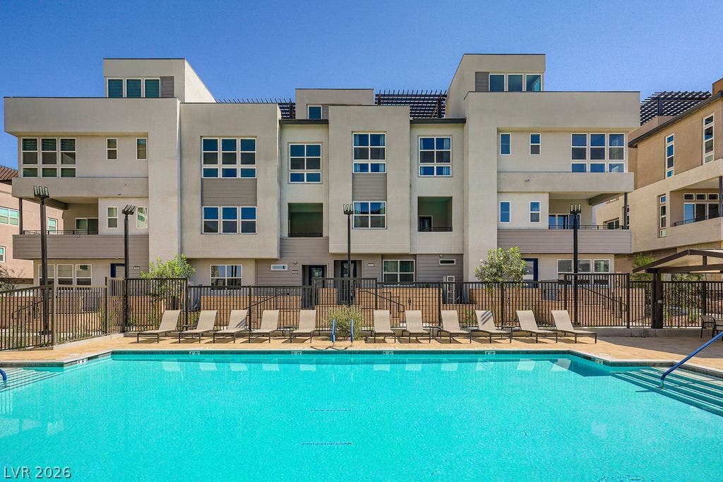 2507 Silent View Avenue, Henderson, NV 89044 Modern multi-level architecture stands alongside a pristine swimming pool under clear blue skies.