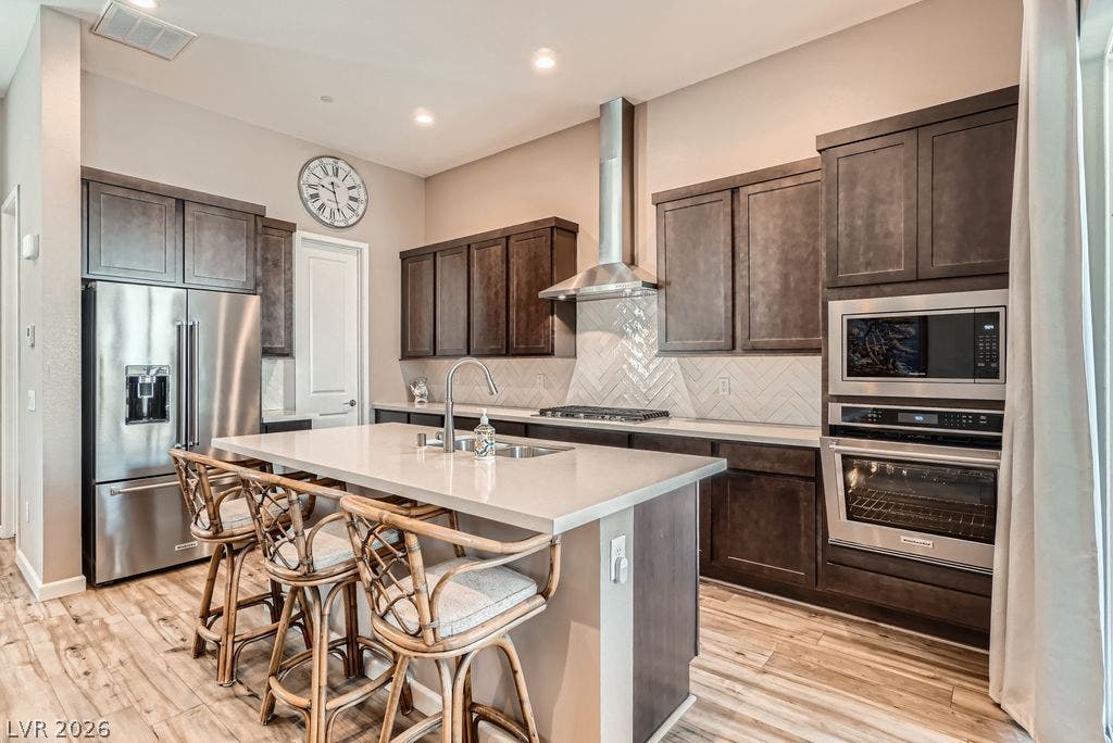 2507 Silent View Avenue, Henderson, NV 89044 Rich wood cabinetry and a central island ground this functional culinary workspace.