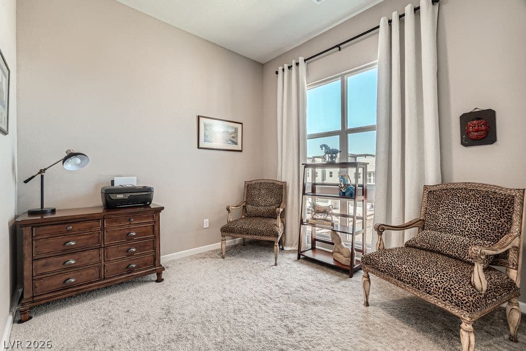 2507 Silent View Avenue, Henderson, NV 89044 A tall window draws natural light into this versatile workspace featuring high ceilings and plush carpeting.
