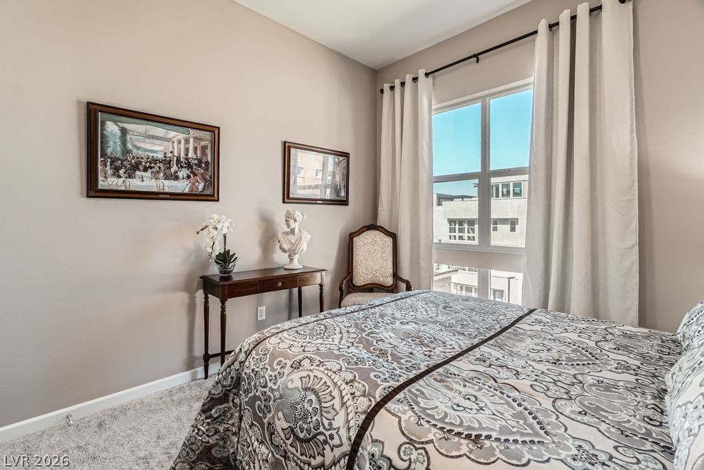 2507 Silent View Avenue, Henderson, NV 89044 Plush carpeting and a large window framing neighborhood views enhance this cozy bedroom space.