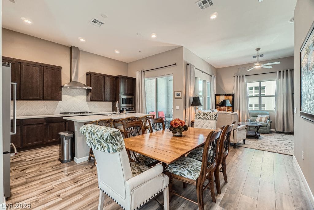 2507 Silent View Avenue, Henderson, NV 89044 Gleaming wood-look floors anchor this airy open concept kitchen and dining space.
