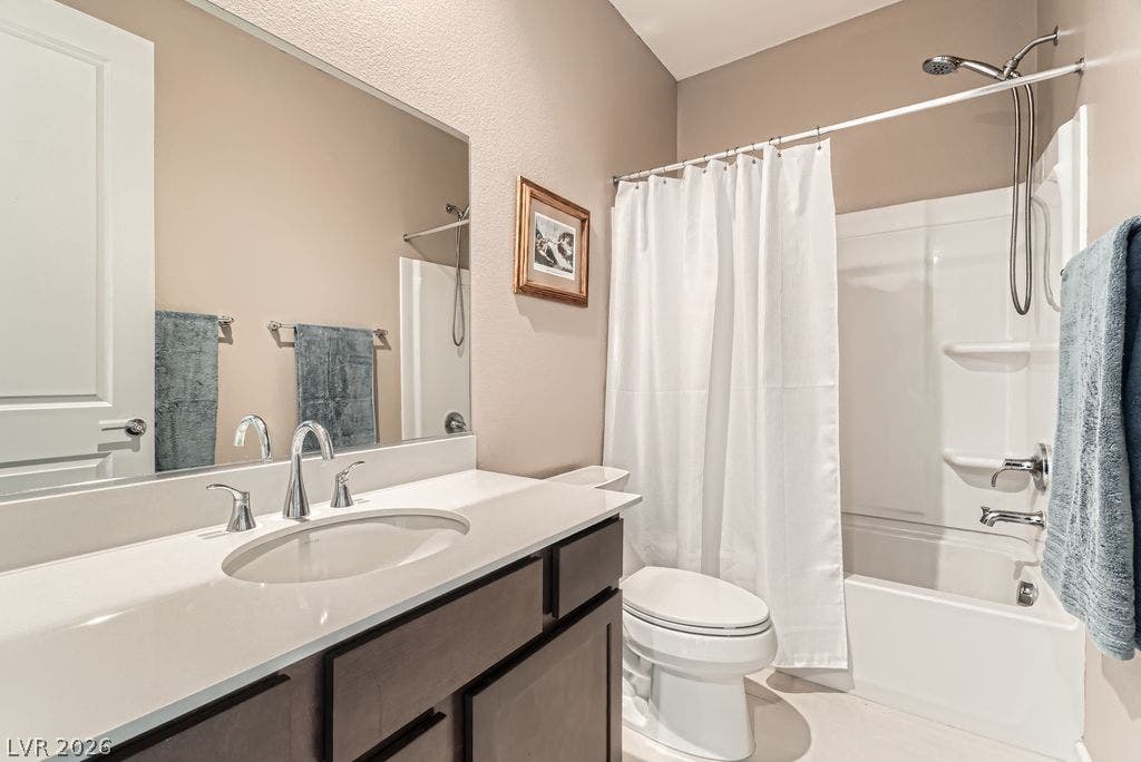 2507 Silent View Avenue, Henderson, NV 89044 Smooth stone countertops and a modern tub shower enclosure highlight this clean, updated bathroom.