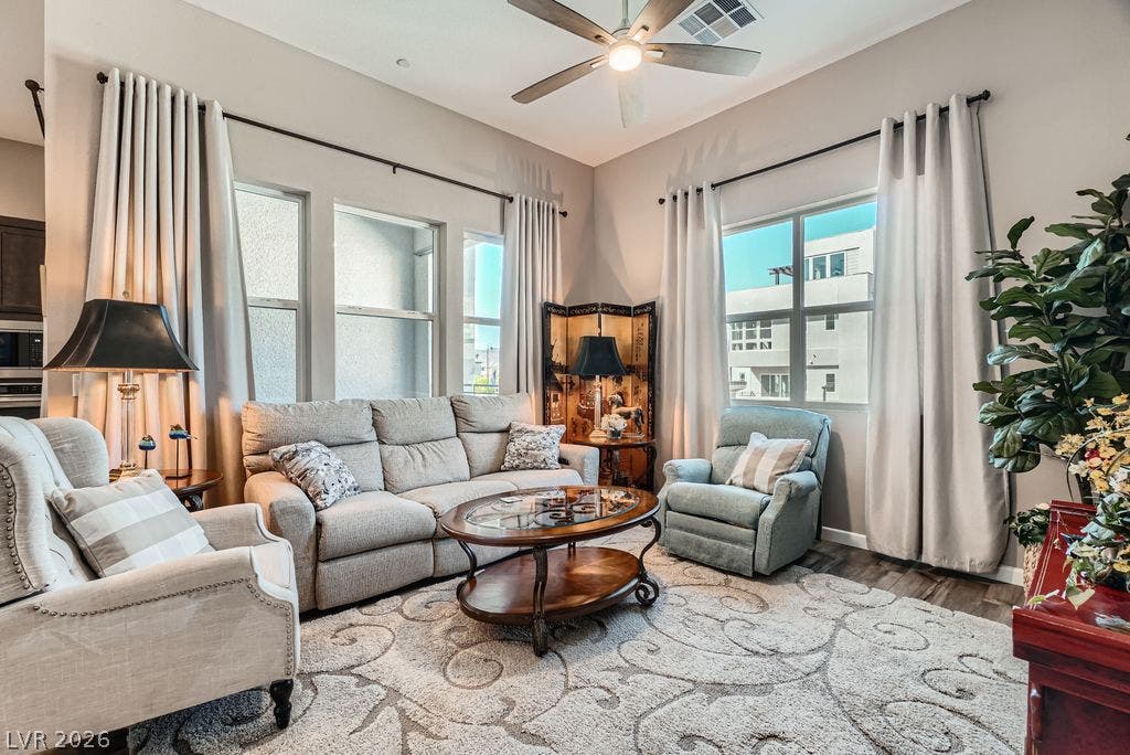 2507 Silent View Avenue, Henderson, NV 89044 Sunlight streams through tall windows highlighting the wood flooring and lofty ceilings.