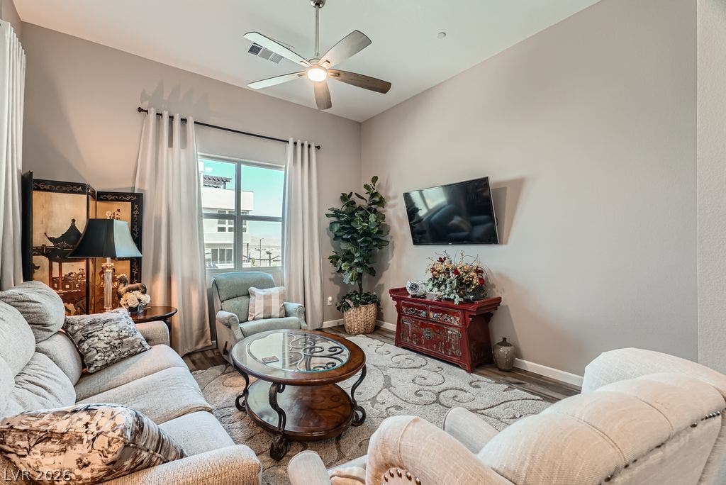 2507 Silent View Avenue, Henderson, NV 89044 A spacious living area features high ceilings, wood-style flooring, and a large window.