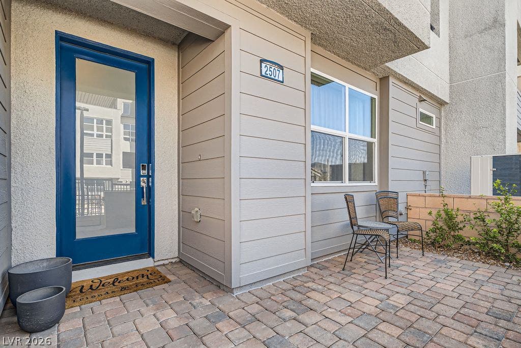2507 Silent View Avenue, Henderson, NV 89044 A welcoming entryway features a glass door alongside a private brick paver patio.