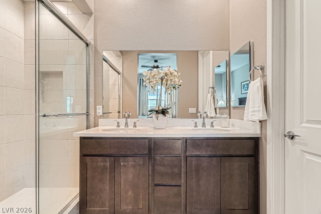 2507 Silent View Avenue, Henderson, NV 89044 A spacious double vanity anchors this modern bathroom with its glass-enclosed walk-in shower.