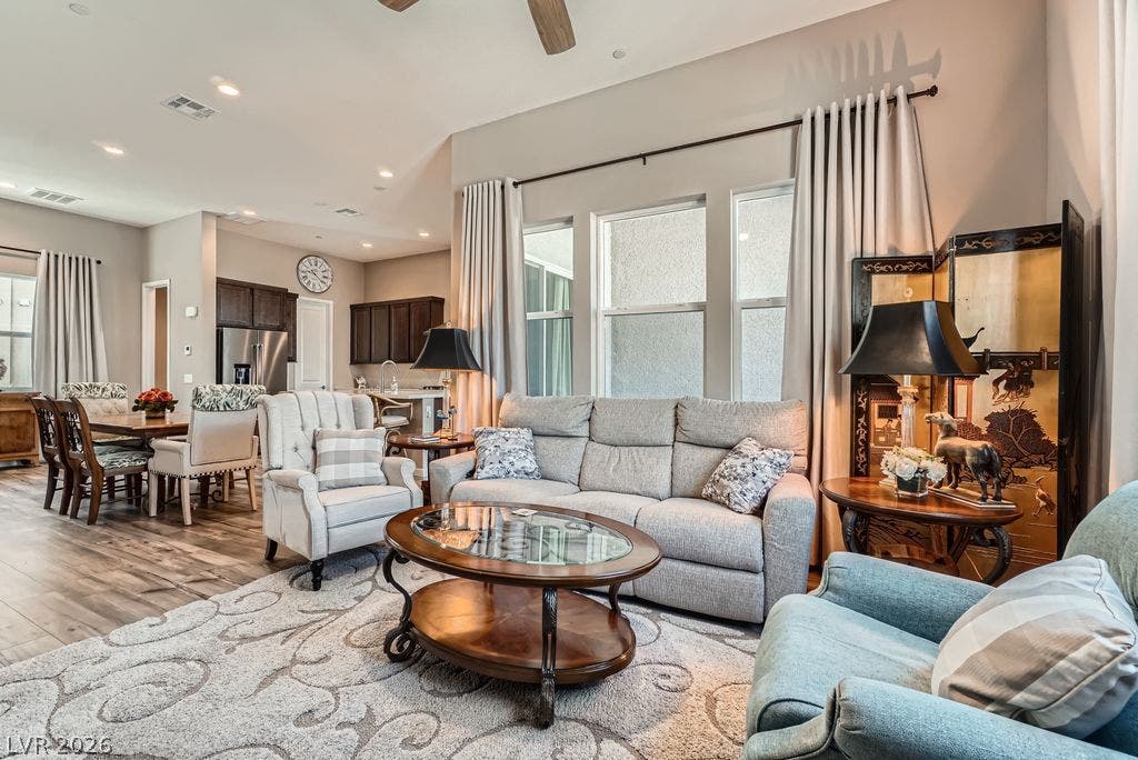 2507 Silent View Avenue, Henderson, NV 89044 High ceilings and generous windows define this open-concept main level with rich wood floors.