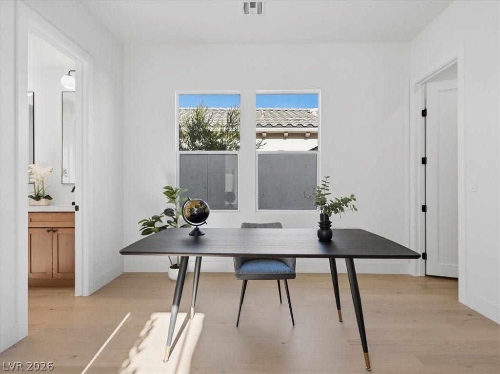 3074 Soft Horizon Way, Las Vegas, NV 89135 A well-lit study with light wood floors offers a peaceful environment for productivity.