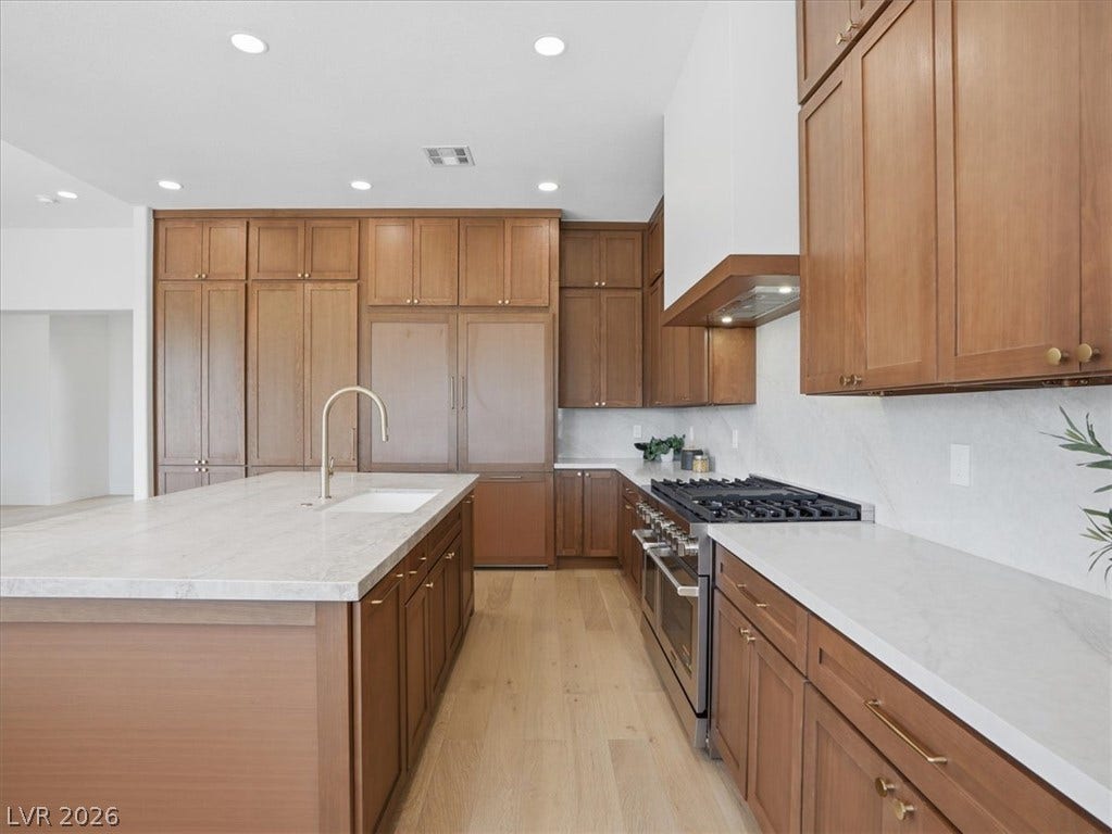 3074 Soft Horizon Way, Las Vegas, NV 89135 Culinary delights await in this modern kitchen with extensive cabinetry and an elegant island.
