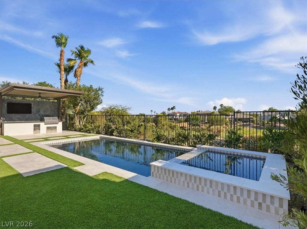 3074 Soft Horizon Way, Las Vegas, NV 89135 An inviting backyard oasis offers a sparkling pool and spa with an integrated outdoor kitchen and bar area.