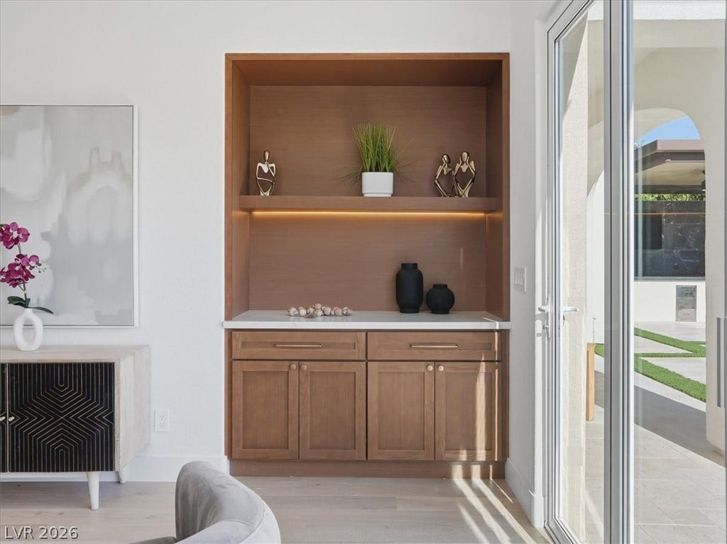 3074 Soft Horizon Way, Las Vegas, NV 89135 A refined dry bar with under-cabinet lighting and ample storage complements a bright interior, opening to an inviting outdoor space.