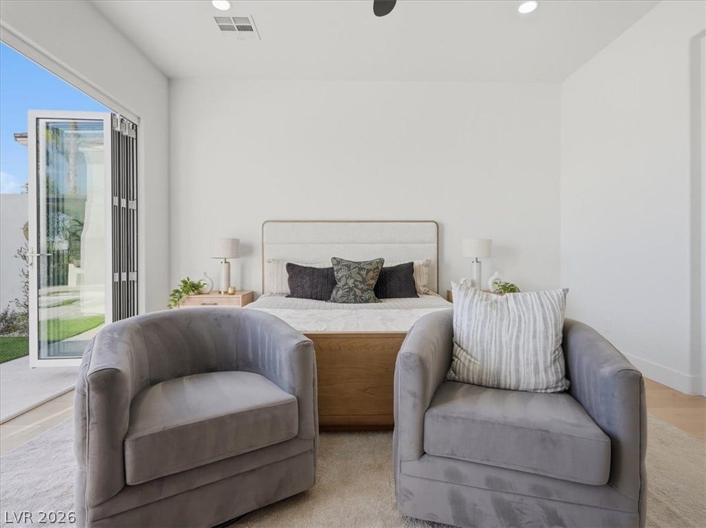 3074 Soft Horizon Way, Las Vegas, NV 89135 Comfortable seating and a private outdoor access elevate this serene bedroom retreat.